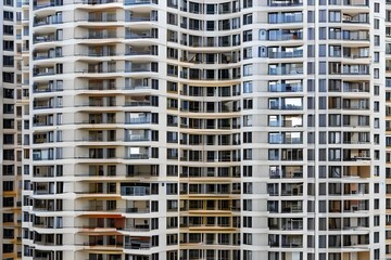 Fototapeta na wymiar Wall of an apartment block with balconies, mady by Generative AI