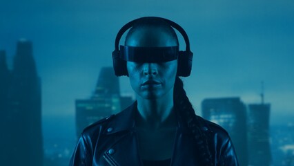 Portrait of cyberpunk girl with a smartphone in a glasses and headphones. Beautiful young woman on...