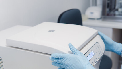 person using centrifuge molecular biology