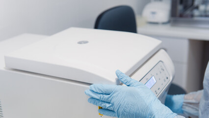 person using centrifuge molecular biology