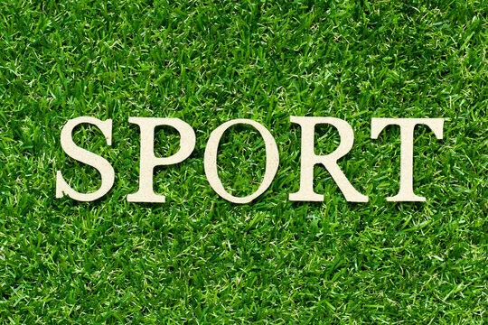 Wood letter in word sport on green grass background - Powered by Adobe