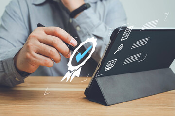 Businessman show icon of top service Quality assurance, Customer rating to service experience and Warranty online application concept, Guarantee, Standards, ISO certification and use laptop on table.