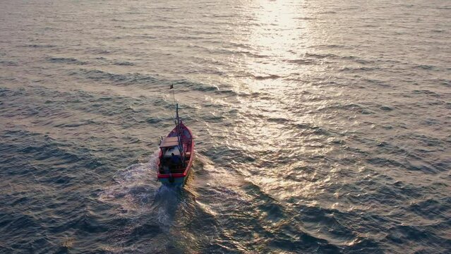 Fishing in Sri Lanka. The boat is moving in the ocean towards the sun. Drone video shot. Traditional tuna fishing in Sri Lanka.