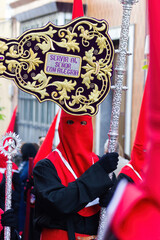 Nazarene carrying a banner during an Holy Week procession.