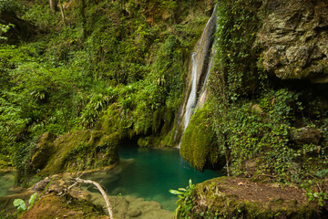View of secret waterfall in the green forest of Castel di Fiori, Umbria