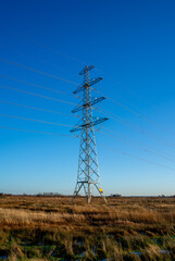 Winter landscape power pylon in the Netherlands

