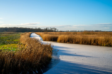 Winter landscape with frozen canal in Drenthe, Netherlands
