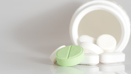 white pills on green background
