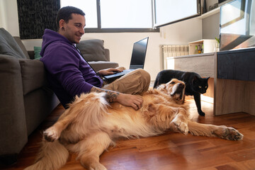 Man working on laptop with pets