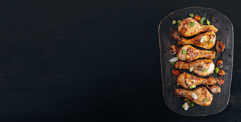 Baked chicken legs. Baked chicken drumstick on paper