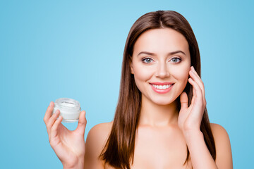 Concept of using moisturizing cream before going to bed. Beautiful cute pretty charming woman is...