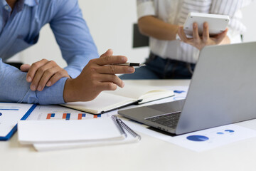 Meeting with financial advisors to analyze market growth reports and discuss financial budget expenditure scenarios in business reports. Financial planning and accounting.