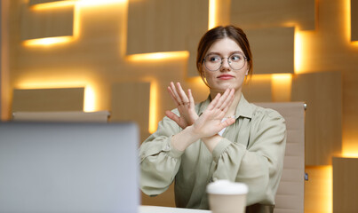 Stop gesture, businesswoman disagree, denial. Woman in office workplace says no.