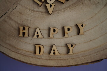 Banner. The word Happy Day. Love on wooden blocks. Theme of love. Wooden letter blocks. Loving, positive emotions
