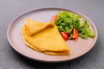 pancake with green salad on plate