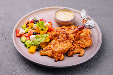 baked golden chicken drumsticks and Greek salad