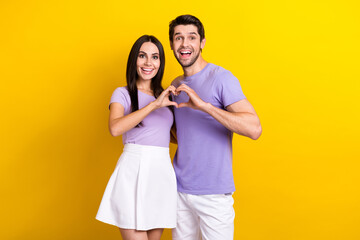 Photo portrait of lovely young lady guy heart gesture fingers excited dressed stylish violet clothes isolated on yellow color background
