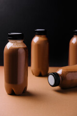 chocolate smoothies milkshake in bottles on brown background