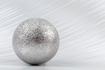 Fototapeta na wymiar Bright festive background. A sparkling ball on a silver background.