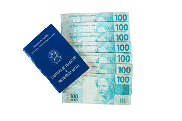 Brazilian work card and banknotes of one hundred reais. labor portfolio and social security
