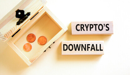 Crypto downfall symbol. Concept words Cryptos downfall on wooden blocks. Beautiful white table white background. Wooden chest with coins. Business and crypto downfall concept. Copy space.