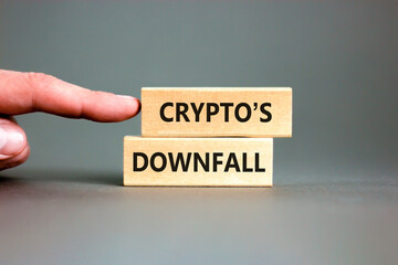 Crypto downfall symbol. Concept words Cryptos downfall on wooden blocks. Beautiful grey table grey background. Businessman hand. Business and crypto downfall concept. Copy space.