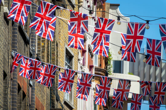British Union Jack flag garlands in a street in London, UK national celebration, king coronation or funeral