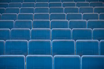 A row of empty chairs in the auditorium of the cinema.