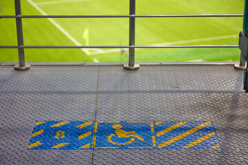 Special fenced area in the football stadium to accommodate fans with disabilities. Wheelchair seating place to watch a football match