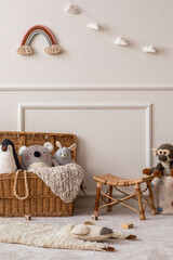 Interior design of kids room interior with wicker basket, plush animal toys, poster, wooden blockers, ladder, white stool, beige wall with stucco and personal accessories. Home decor. Template.