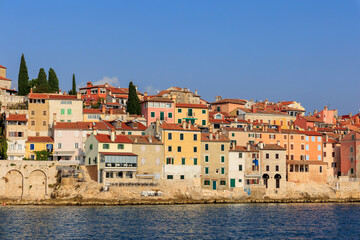 Fototapeta na wymiar The old town of Rovinj with the church of St. Euphemia seen from the sea on a sunny day with blue sky