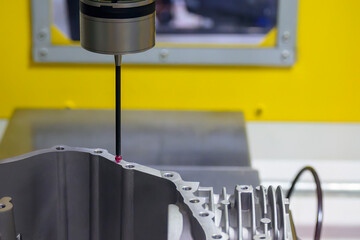 The  3-axis CMM machine measuring the aluminum parts .