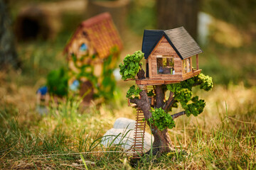 Little dollhouse on front lawn, cute small decorative house on green grass field, environment...