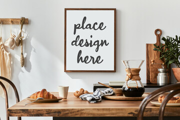 Creative composition of kitchen space with mock up poster frame, wooden table, coffee accessories , kitchen stuff , herbs and personal accessories. Home decor. Template.