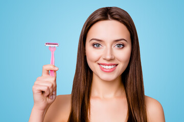 Concept of using razor for armpits. Close up portrait of happy beautiful woman holding pink razor, isolated on grey background