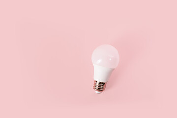 Light bulb for new idea on pink background. Electricity saving.