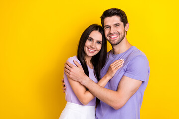 Photo of idyllic peaceful positive partners hug toothy smile empty space isolated on yellow color background