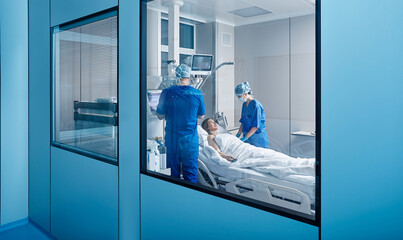 Doctor and nurse attending woman patient in intensive care and checking her health. ICU - obrazy, fototapety, plakaty