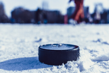 hockey puck lies on the snow close-up