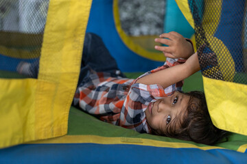 Latin American boy has fun in a bouncy castles