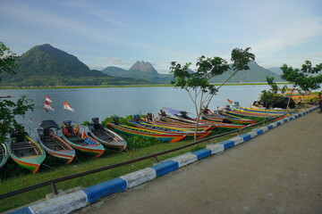 Fishing boats anchored at the Jatiluhur reservoir. Beautiful view of Jatiluhur reservoir with mountains in the background.