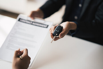 Business car rental, sell or buy service, salesman giving auto key of vehicle to customer after the deal was success.