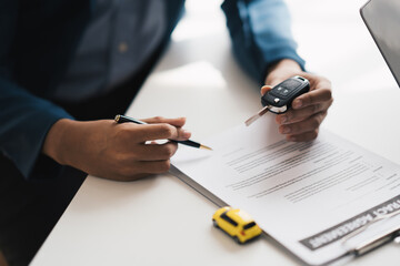 Car agent, sale man explain terms and agreement to customer before giving the car key to customer.