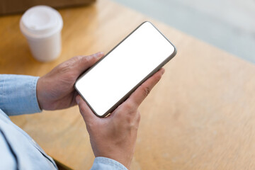 Close up hand of technology in use .  Man working in home office hand smart phone. Concept of using technology in communication.