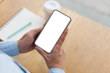 Close up hand of technology in use .  Man working in home office hand smart phone. Concept of using technology in communication.