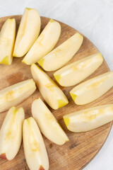 Sliced apple served on the wooden board