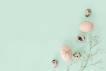 Easter card. Decorated Easter eggs on a green background. Congratulations on Easter. Easter composition with flowers and various eggs. quail eggs for easter