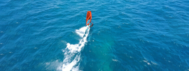 Aerial drone ultra wide panoramic photo with copy space of wind surfer cruising in high speed in...