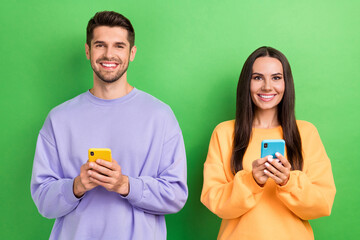 Photo of cheerful positive boyfriend girlfriend wear sweatshirts chatting telegram facebook...