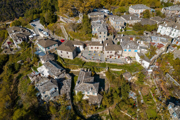 aerial view of the traditional village Mikro Papigo with with stone buildings and  astraka mountain as background during  fall season in  zagori Greece